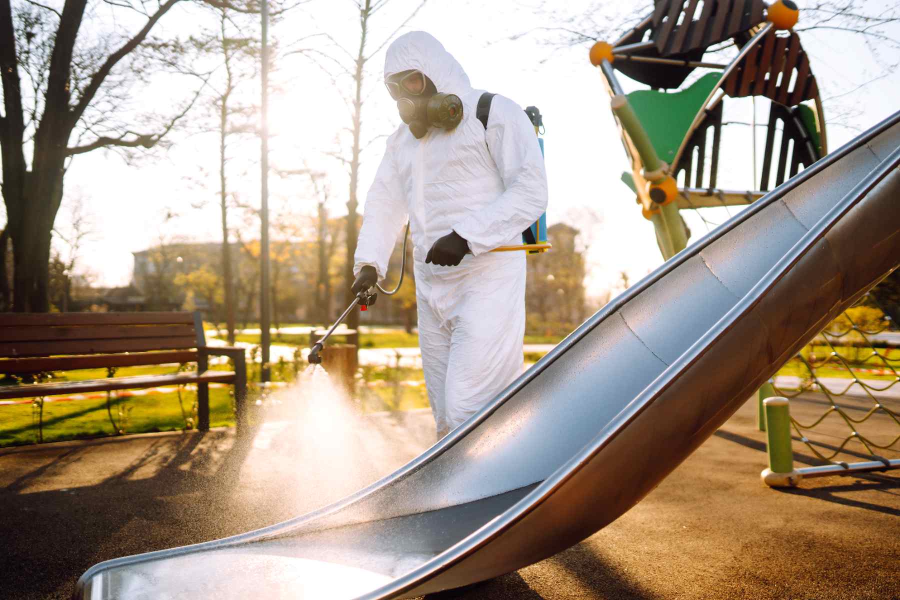 man-wearing-protective-suit-disinfecting-the-playg-2026-03-19-22-08-49-utc